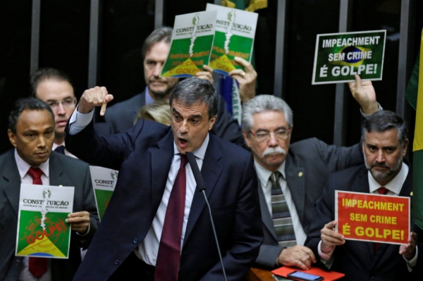 Brazil's General Attorney Jose Eduardo Cardozo speaks during a session to review the request for Brazilian President Dilma Rousseff's impeachment at the Chamber of Deputies in Brasilia, Brazil April 15, 2016. The banners read "Impeachment without a crime is a coup." REUTERS/Ueslei Marcelino TPX IMAGES OF THE DAY